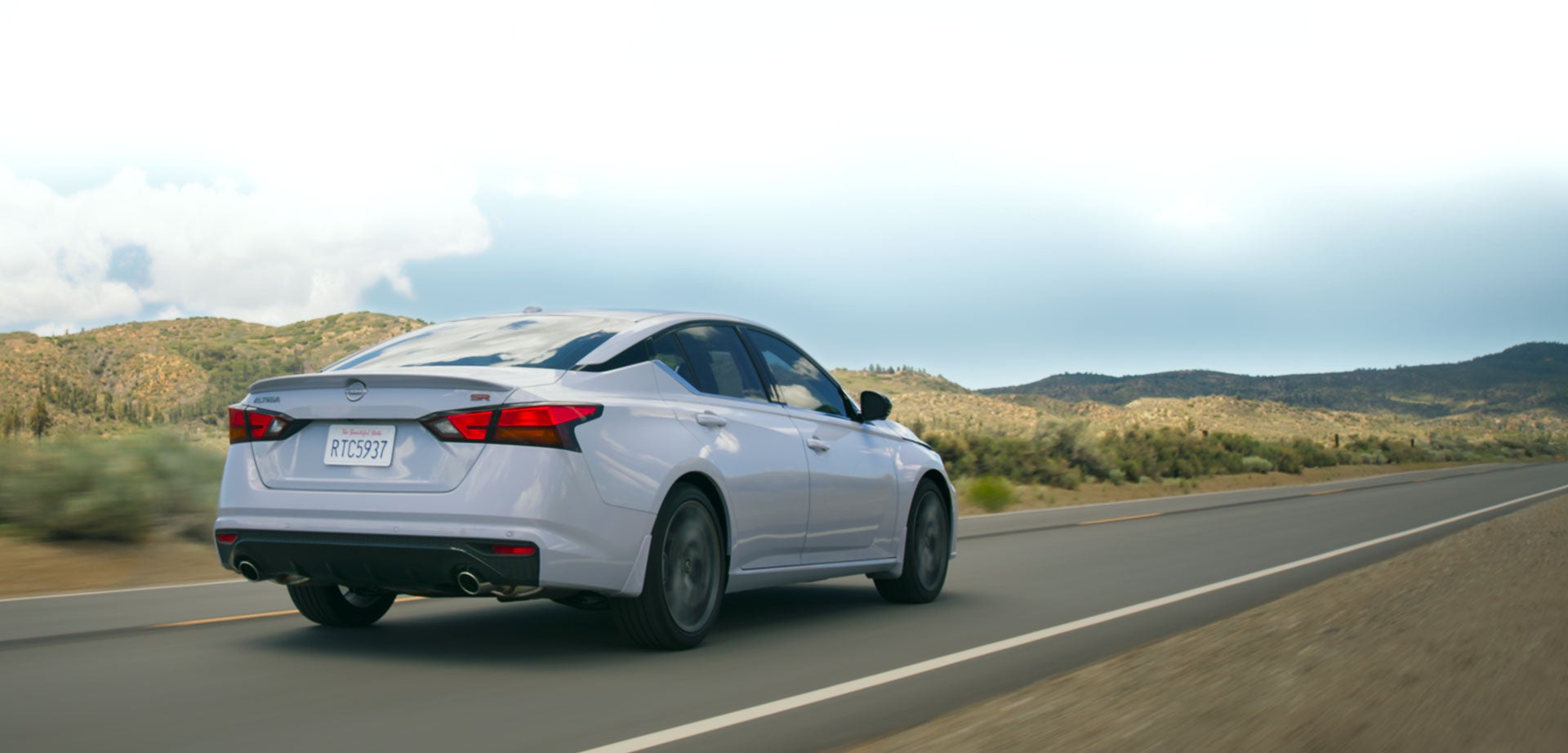 Nissan Altima driving on an open highway